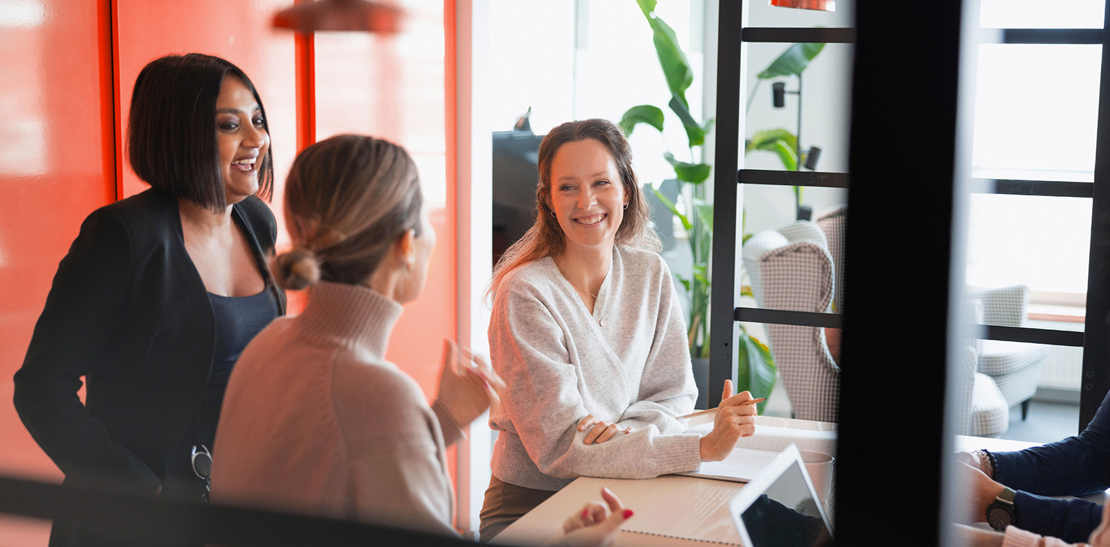 cheerful female colleagues sitting over table office